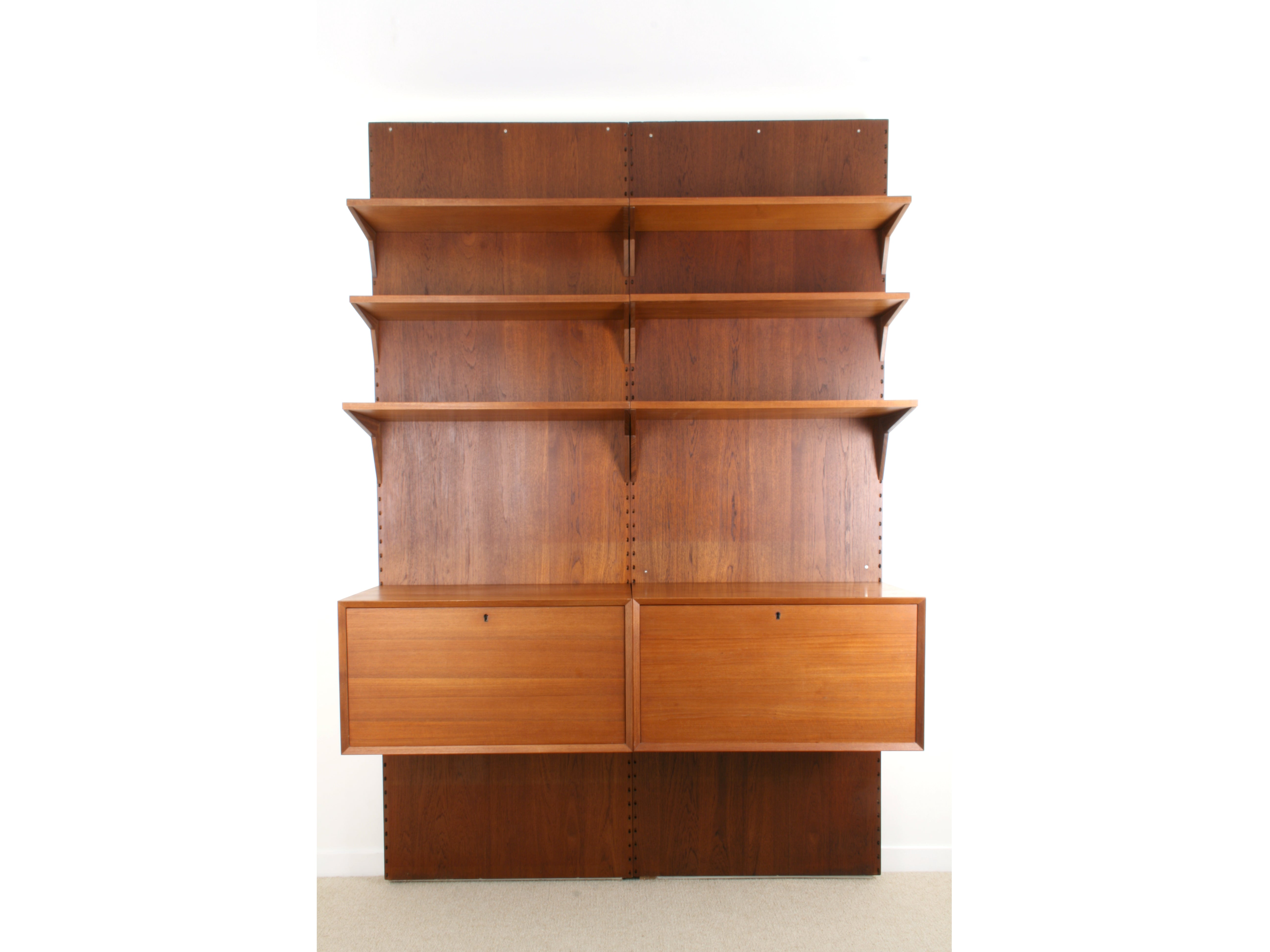 Poul Cadovius Danish Mid Century Teak Modular System. Two cabinets and six shelves mounted of two wall panels.
