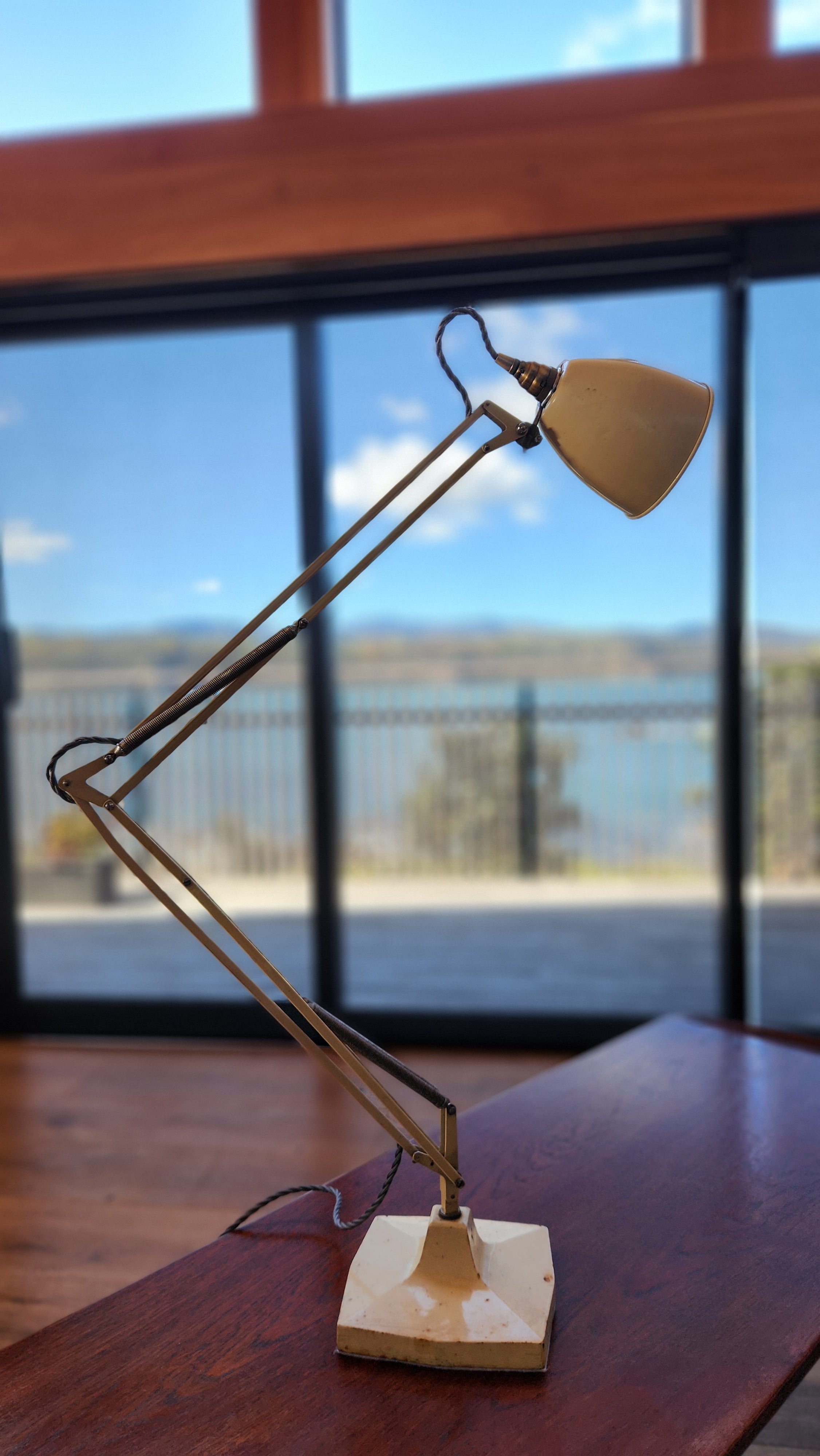 A cream coloured mid century anglepoise lamp by Herbert Terry. height extended.