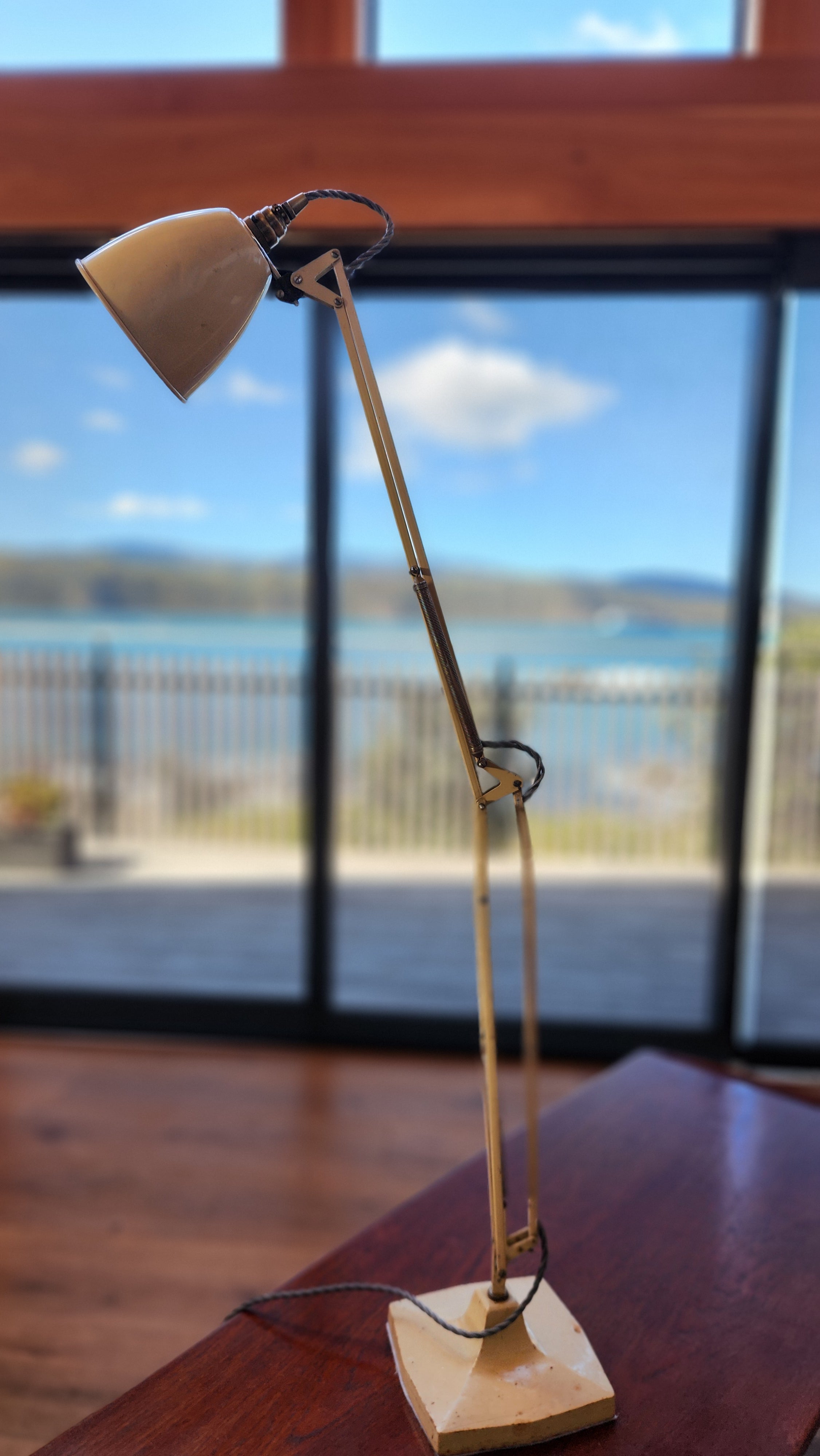 A cream coloured mid century anglepoise lamp by Herbert Terry. A model 1209. Fully extended in height.